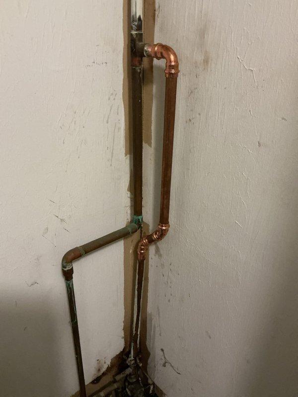 Replaced existing 50-gallon electric water heater with new Bradford White unit and brought installation up to current code compliance. Installation included positioning unit in water pan with drain line routed to floor drain, installing thermal expansion tank, and completing proper electrical bonding of the system. Removed and hauled away old water heater and water softener unit from premises.
