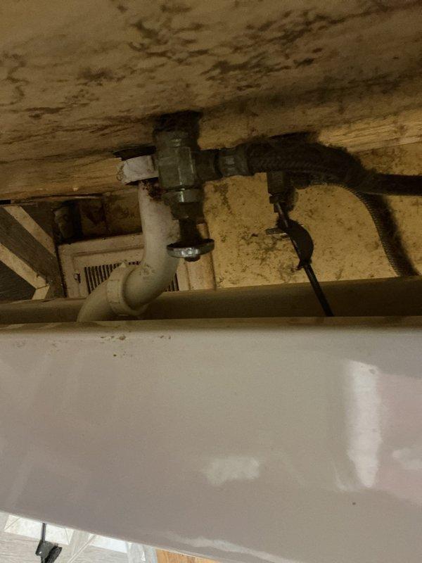 Responded to a slow-draining bathroom pedestal sink. Upon inspection, accessed the drain assembly from below through the basement ceiling area where the waste line and shut-off valve were visible. Cleared the obstruction in the drain line, restoring proper drainage flow to the fixture. Tested the sink to confirm the issue was resolved and proper drainage was restored.
