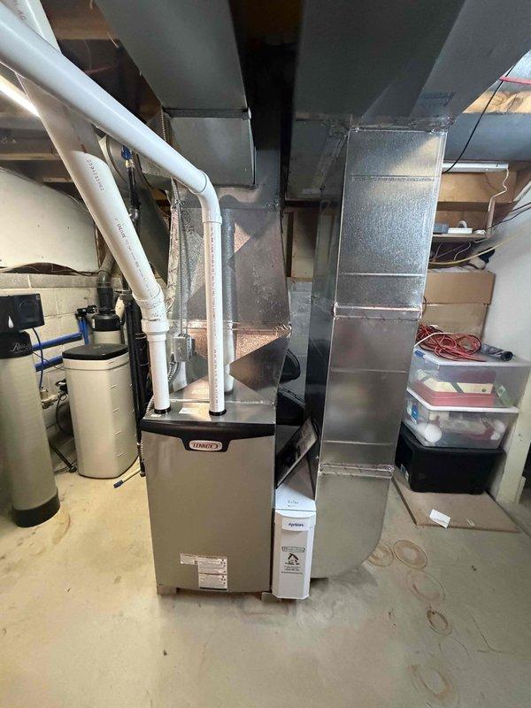 Completed installation of new Lennox 90% AFUE high-efficiency gas furnace in basement mechanical room. Installed white PVC intake and exhaust venting routed through exterior wall per manufacturer specifications. Connected supply and return ductwork to existing metal duct system. Installed carbon monoxide detector in compliance with local building codes. Tested furnace operation, verified proper ignition sequence, and confirmed all safety controls functioning correctly. System operational and heating efficiently.
