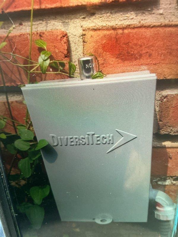 Responded to failed inspection for missing tamper cap on HVAC installation. Inspected copper refrigerant line set with brass ball valves and exterior disconnect box, verified tamper cap was not properly threaded during initial installation. Reinstalled and secured tamper cap to manufacturer specifications to bring system into compliance with code requirements.