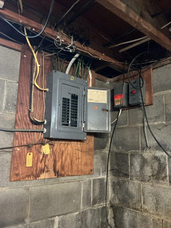 Installed dedicated electrical circuit for septic system in accordance with job specifications. Mounted new electrical panel on plywood backing against concrete block wall in basement utility area, completing all necessary wiring connections with proper conduit routing through exposed ceiling joists to ensure code-compliant power supply for septic equipment operation.