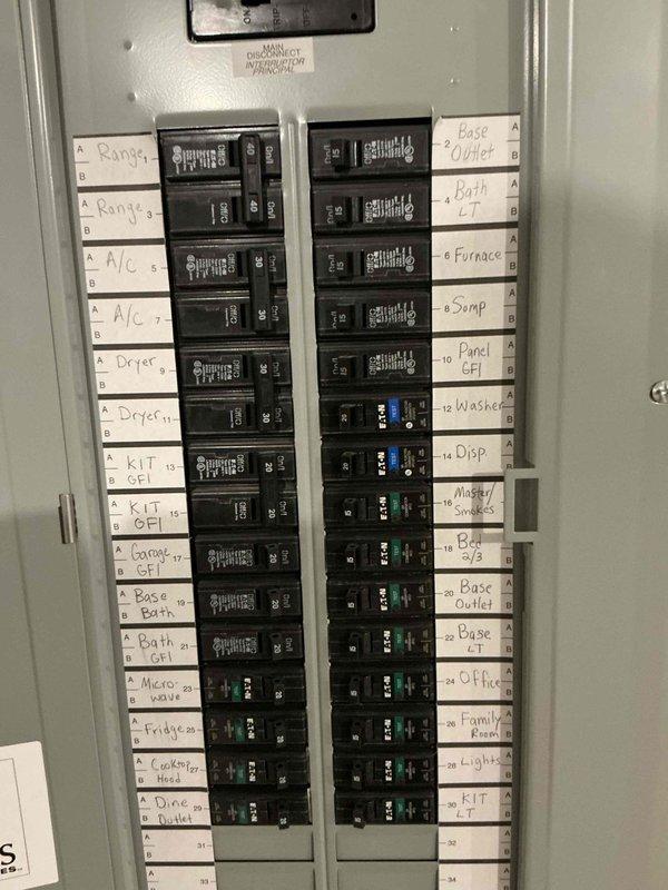 Conducted on-site evaluation for whole-house generator installation. Assessed existing electrical infrastructure including main service panel with dual-column breaker configuration serving multiple dedicated circuits for major appliances, HVAC systems, and general branch circuits. Documented current panel capacity and circuit distribution to determine proper sizing requirements for automatic transfer switch integration. Photographed secondary electrical panel installation on OSB backing, noting existing digital monitoring system and telecommunications equipment that will require coordination during generator interconnection. Evaluated wire routing pathways and conduit access points for transfer switch installation. Provided comprehensive documentation of electrical system layout to develop accurate material list and labor estimate for generator installation project.