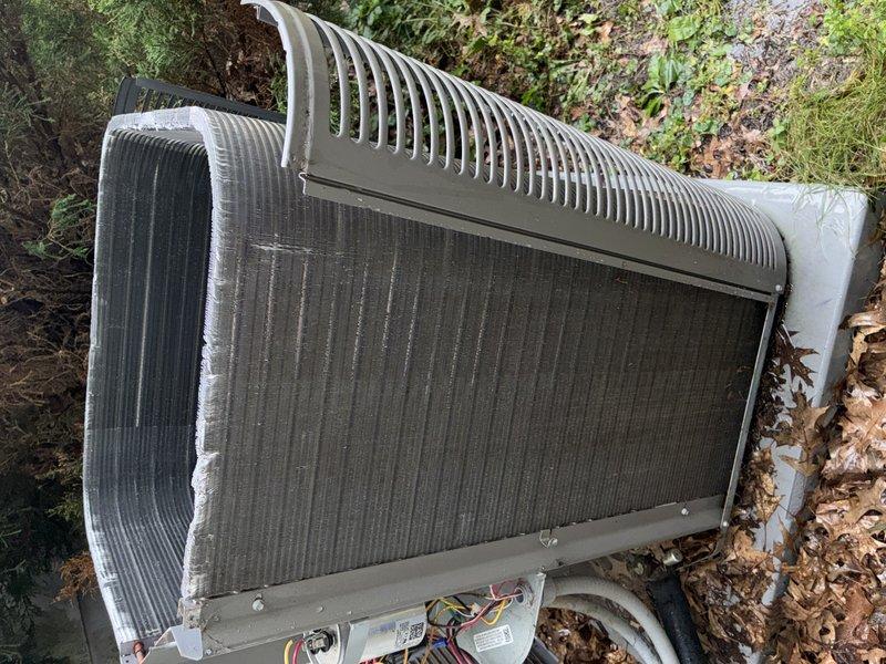 Completed preventive maintenance inspection on residential split-system air conditioning unit. Performed visual assessment of outdoor condenser, confirming heat exchanger coils and aluminum fins in serviceable condition with minimal debris accumulation. Verified refrigerant line connections secure with protective caps intact, electrical components and wiring properly seated, and unit housing structurally sound. Documented equipment condition through photographic records for maintenance history tracking.