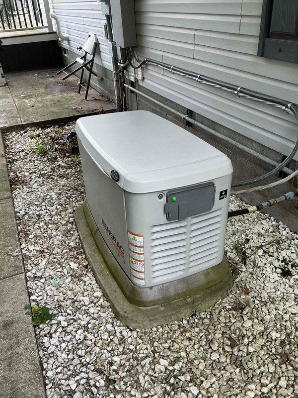 Performed annual preventive maintenance on 20kW residential standby generator unit. Conducted comprehensive battery load test using diagnostic equipment, confirming battery health at 100% capacity with proper voltage output of 34.2V and acceptable internal resistance of 15.36 mΩ. Verified all electrical connections, inspected gas line and conduit installations along exterior wall, and confirmed generator control panel operation with green indicator light showing system ready status.