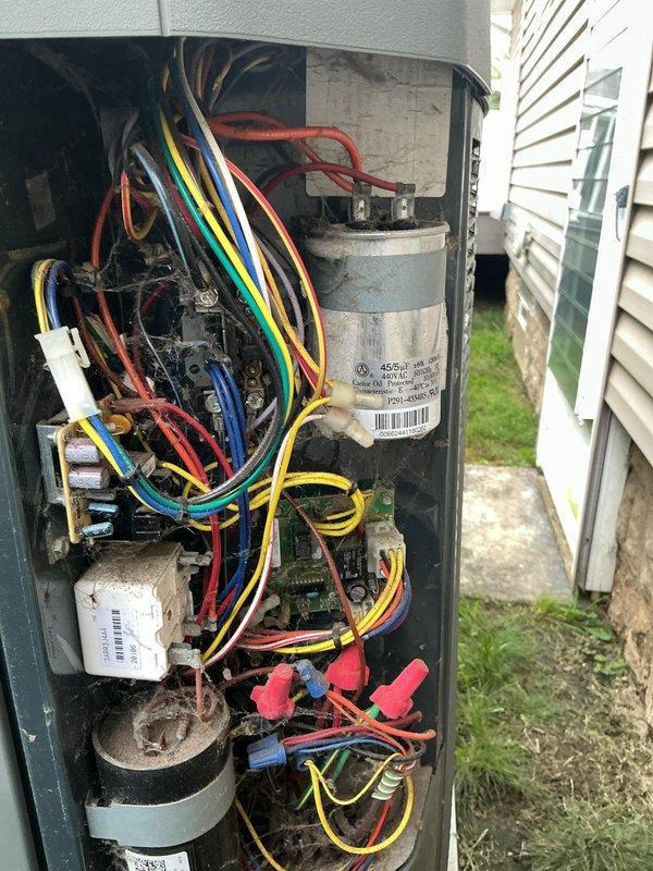 Completed scheduled maintenance visit on residential air conditioning system over 10 years old for MVP customer. Performed comprehensive inspection of outdoor condensing unit, accessing electrical compartment to examine all internal components including capacitor, wiring connections, and terminal blocks. All electrical connections were verified secure, capacitor tested and found operational, and unit exterior inspected for proper airflow through louvers and top grille assembly. System operating within normal parameters upon completion of service call.