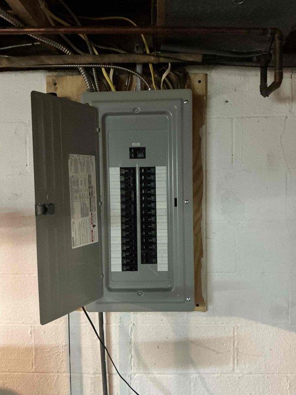 Completed on-site assessment for dehumidification system installation in basement mechanical room. Evaluated existing HVAC infrastructure including Daikin furnace unit, electrical panel capacity, and available space for equipment placement. Documented current conditions with photographs of electrical service panel showing breaker configuration and existing HVAC equipment layout to determine optimal dehumidifier positioning and electrical requirements for integration with existing system.