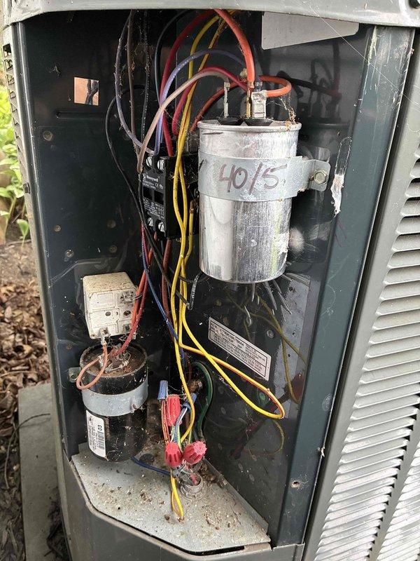 Completed MVP cooling maintenance visit on residential HVAC system. Performed inspection of indoor air handler unit and outdoor condensing unit, documenting equipment condition with photographs. Indoor unit showed proper installation with adequate drainage piping and ventilation components in place. Outdoor unit inspection revealed aging dual-run capacitor marked 40/5 MFD with visible weathering and accumulated debris in base pan; all electrical connections were secure with proper wire capping. System operational at time of service visit.