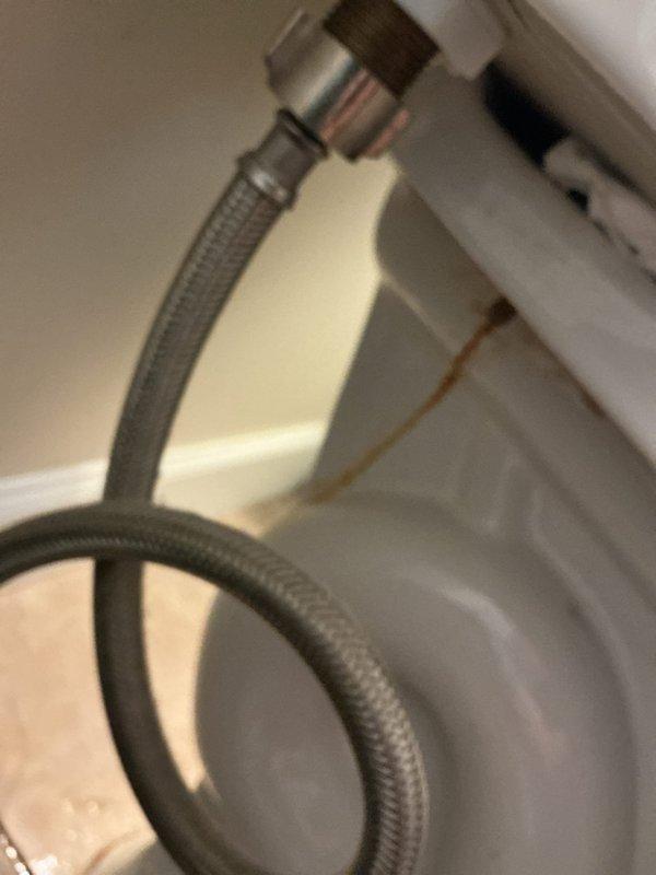 Responded to service call for multiple plumbing issues in residential bathroom. Inspected two 19-year-old toilets: first unit exhibited water leakage from base indicating failed wax ring seal; second unit produced abnormal air horn noise during fill cycle suggesting faulty fill valve or ballcock assembly. Additionally assessed bathroom sink faucet with active leak, likely caused by deteriorated internal seals or cartridge failure. Documented all fixtures with photographs including chrome two-handle centerset faucet assembly and supply line connections for repair recommendations and future service reference.