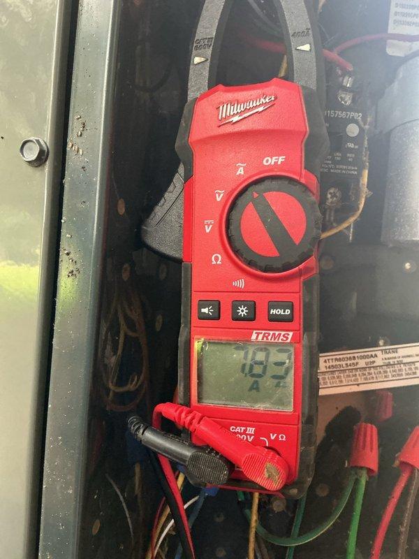 Completed seasonal tune-up on evaporative cooling system, including inspection of cellulose media pads which showed normal mineral deposits and discoloration from use. Verified electrical system operation with amp draw reading of 183A on main circuit, confirming proper motor and component function within manufacturer specifications.