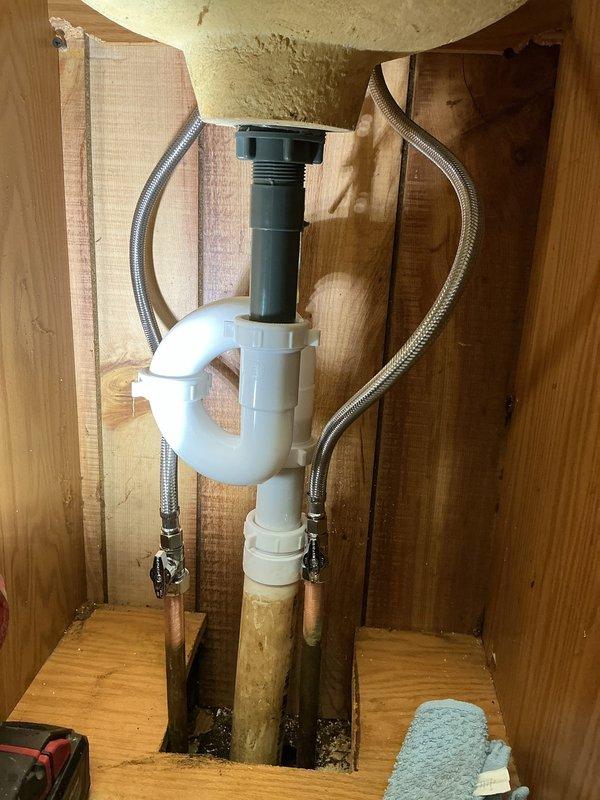 Installed two customer-supplied lavatory faucets at the property. The first-floor pedestal sink installation included replacing supply lines while retaining existing functional shut-off valves and reusing portions of the 1-1/4" trap assembly to avoid drywall removal for wall-concealed connections. The second-floor vanity installation required replacement of shut-off valves and supply lines, along with installing a new 1-1/2" PVC male adapter and reconfiguring the trap assembly to establish proper drainage connections.