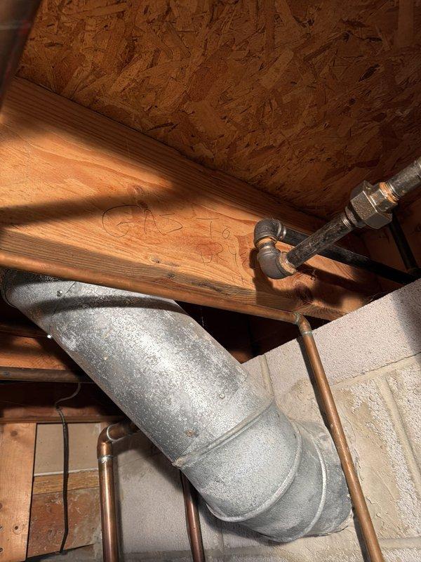 Responded to service call for gas line assessment prior to dryer installation. Previous installation attempt by third-party appliance installer was halted due to concerns about shutting off gas supply to the residence. Performed comprehensive inspection of existing natural gas piping system in crawlspace and attic areas, examining gas line routing, connections, and shutoff valve accessibility. Verified proper gas line sizing and configuration for dryer connection. Documented existing copper gas piping, support strapping, and connection points throughout the mechanical spaces. Confirmed gas system integrity and provided clearance for appliance installation to proceed safely.