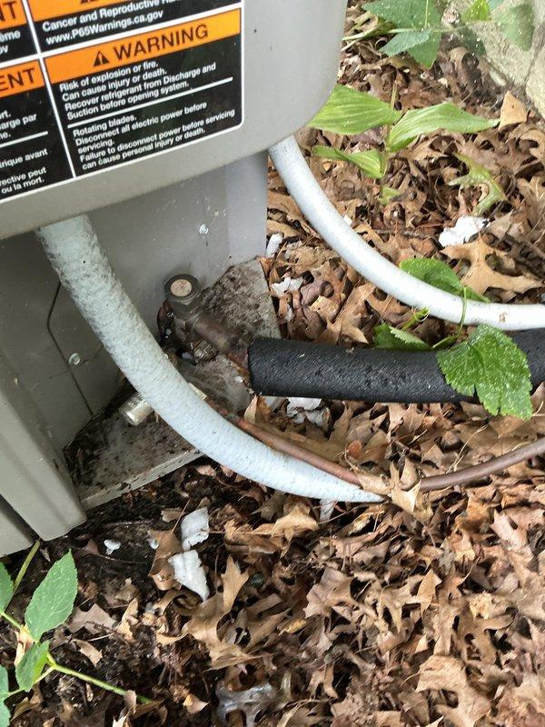 Responded to no cooling complaint on six-year-old residential air conditioning system with frozen refrigerant line that had thawed after unit was shut off. Upon arrival, inspected outdoor condensing unit and found capacitor and electrical connections showing signs of wear and environmental exposure. Evaluated system components, checked refrigerant lines for proper insulation integrity, and assessed electrical connections including capacitor wiring. Documented equipment condition with photographic evidence showing outdoor unit surrounded by debris accumulation and internal components with dust buildup. Addressed whole-house cooling failure by identifying frozen line condition as symptom of underlying airflow or refrigerant issue requiring further system evaluation.