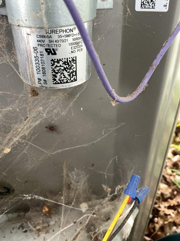 Responded to no cooling complaint on six-year-old residential air conditioning system with frozen refrigerant line that had thawed after unit was shut off. Upon arrival, inspected outdoor condensing unit and found capacitor and electrical connections showing signs of wear and environmental exposure. Evaluated system components, checked refrigerant lines for proper insulation integrity, and assessed electrical connections including capacitor wiring. Documented equipment condition with photographic evidence showing outdoor unit surrounded by debris accumulation and internal components with dust buildup. Addressed whole-house cooling failure by identifying frozen line condition as symptom of underlying airflow or refrigerant issue requiring further system evaluation.