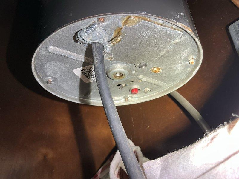 Responded to report of water leak under kitchen sink with concern about loose spigot or malfunctioning garbage disposal. Upon inspection, identified active leak originating from garbage disposal unit and discharge connections. Assessed mounting hardware, drain connections, and disposal discharge pipe for proper seal and alignment. Placed absorbent materials beneath unit to contain water damage during diagnostic evaluation. Inspected water heater components in adjacent area as part of comprehensive plumbing system assessment. Verified all connections, tightened mounting assemblies, and tested for proper drainage flow to resolve leak issue.