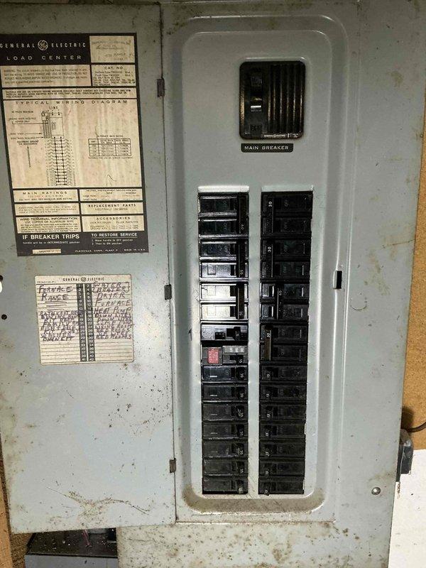 Conducted on-site assessment for whole home backup generator installation. Evaluated existing electrical infrastructure, including main service panel configuration and capacity. Documented current General Electric load center with dual columns of circuit breakers and main breaker disconnect. Assessed panel condition, age, and available capacity for generator integration. Photographed electrical panel interior, circuit breaker arrangement, and service entrance wiring to determine compatibility requirements for automatic transfer switch installation. Evaluated installation location accessibility, wall construction, and structural considerations for generator placement. Reviewed existing electrical system to calculate total home load requirements and determine appropriate generator sizing specifications for complete backup power coverage.