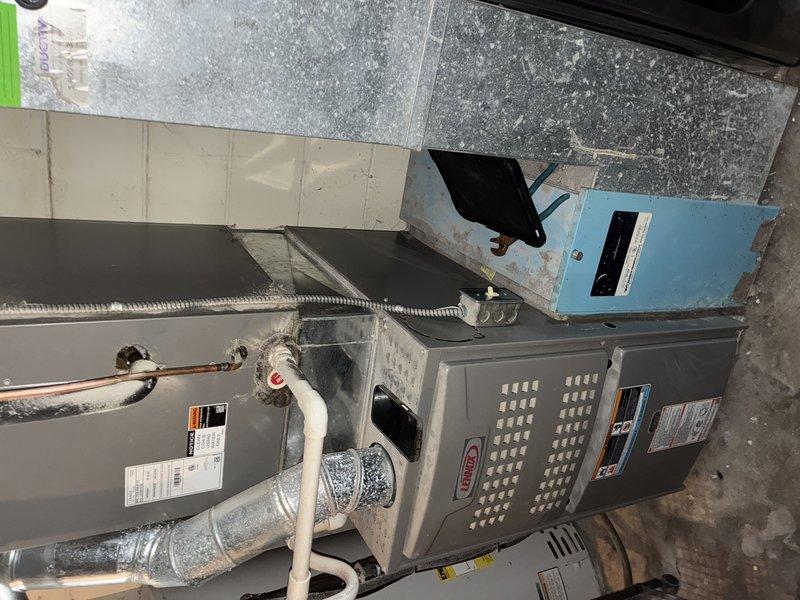 Completed MVP cooling maintenance visit on 6-year-old system. Inspected indoor air handler unit in mechanical room and outdoor condensing unit. Outdoor condenser coil showed significant accumulation of dirt, debris, and organic material on fins, confirming need for previously recommended acid wash treatment. Indoor unit and refrigerant lines appeared in serviceable condition with proper connections intact. Documented equipment condition with photos for maintenance records.