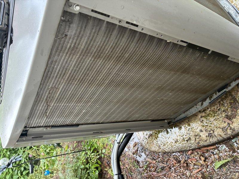 Completed MVP cooling maintenance visit on 6-year-old system. Inspected indoor air handler unit in mechanical room and outdoor condensing unit. Outdoor condenser coil showed significant accumulation of dirt, debris, and organic material on fins, confirming need for previously recommended acid wash treatment. Indoor unit and refrigerant lines appeared in serviceable condition with proper connections intact. Documented equipment condition with photos for maintenance records.