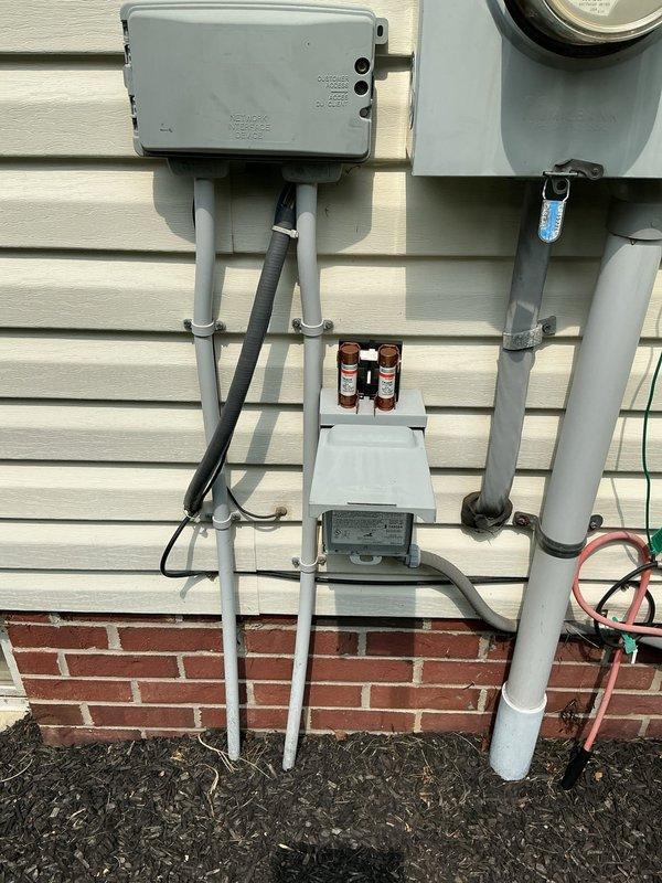 Responded to service call for 6-year-old air conditioning system with thermostat malfunction and inadequate temperature control. Upon inspection of the outdoor condensing unit and electrical connections, documented existing installation conditions including exterior electrical components, PVC conduit routing, and AC unit placement. System evaluated for proper operation and potential control board or thermostat issues affecting temperature regulation performance.