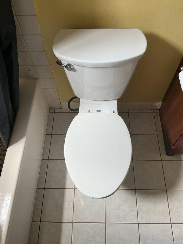 Installed a new American Standard Cadet comfort height toilet in residential bathroom. Removed existing fixture and replaced with two-piece white porcelain unit featuring chrome flush lever. Completed installation in approximately two hours, tested for proper operation and verified no leaks.