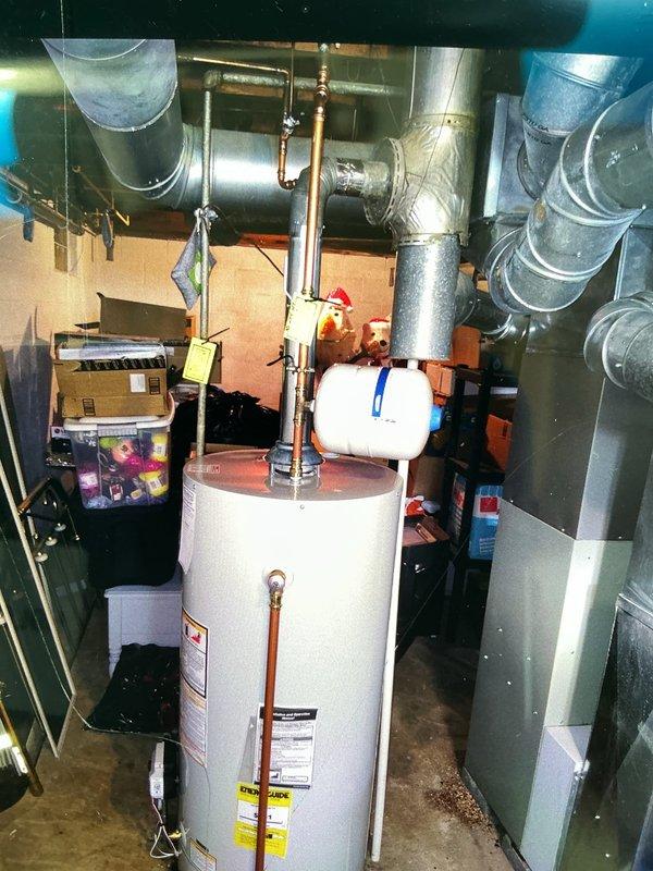Responded to service call for failed 40-gallon gas water heater in basement utility room. Conducted on-site assessment of existing unit, which showed copper supply piping, expansion tank, and standard venting configuration through metal ductwork. Documented equipment specifications and installation conditions through photographic documentation. Customer rescheduled appointment for Friday to proceed with estimate review and replacement options.