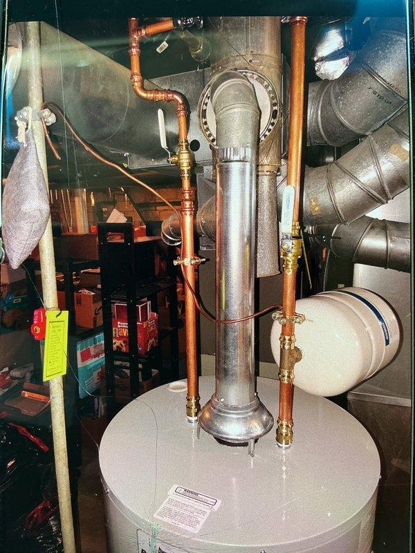 Responded to service call for failed 40-gallon gas water heater in basement utility room. Conducted on-site assessment of existing unit, which showed copper supply piping, expansion tank, and standard venting configuration through metal ductwork. Documented equipment specifications and installation conditions through photographic documentation. Customer rescheduled appointment for Friday to proceed with estimate review and replacement options.
