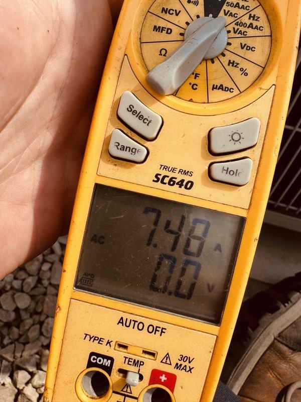 Completed annual AC tune-up on 12-year-old system. Performed diagnostic testing of control board with illuminated display showing proper operation, verified system voltage readings at 748VAC using digital multimeter, and installed complimentary carbon monoxide detector for customer safety.