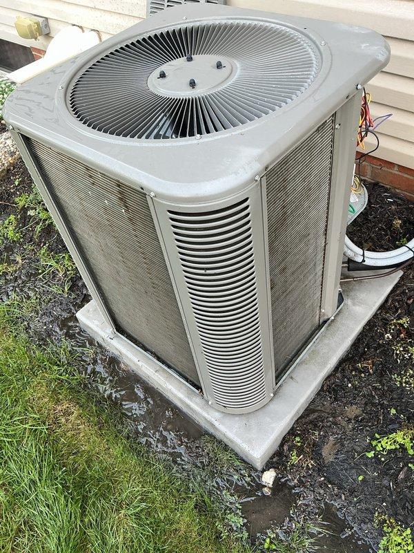 Completed MVP recurring cooling maintenance visit on residential split system. Performed standard system diagnostics with digital testing equipment, recording operational readings of 684 on measurement device. Inspected outdoor condenser unit positioned on concrete pad, verified fan operation and airflow through louvers, and assessed unit condition showing normal weathering consistent with outdoor exposure. Confirmed electrical connections secure and system operating within normal parameters.