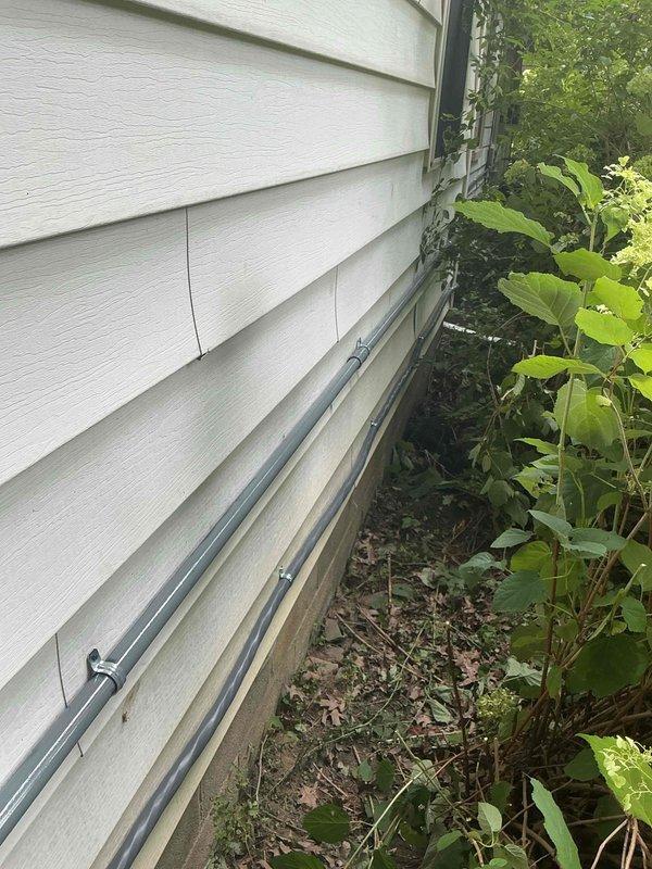 Completed installation of 10KW standby generator with 16-circuit transfer switch at residential property. Ran 15 feet of gas line from existing service to generator location and installed 20 feet of electrical conduit along exterior foundation to connect unit to main electrical panel. Mounted generator on concrete pad, staged and connected transfer switch in attic space with proper wire terminations, installed oil heater and battery, and tested all connections for proper operation and automatic transfer functionality.