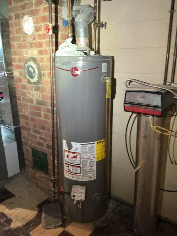 Responded to service call for leaking hot water tank and basement tub faucet replacement. Upon inspection, identified leak originating from spigot on Rheem gas water heater. Replaced faulty spigot valve to stop water leakage and verified proper seal. Proceeded to basement bathroom where existing tub faucet required replacement due to wear and malfunction. Removed old faucet assembly, installed new faucet unit, and tested for proper water flow and temperature control. All plumbing connections secured and checked for leaks. System restored to full operational status.