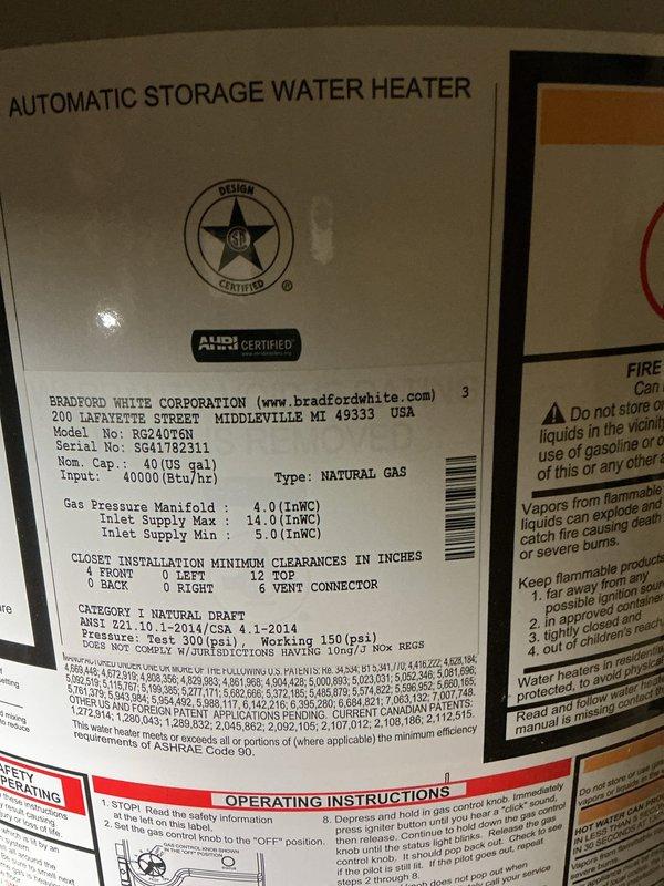 Responded to service call for water leaking from bottom of natural gas water heater. Upon inspection, identified Bradford White model RG240T6N 40-gallon automatic storage water heater with active leak at base of tank. Documented existing conditions including corroded copper piping connections and aged mechanical components in utility space. Tank failure determined to be non-repairable due to internal corrosion causing bottom leak, requiring full unit replacement.