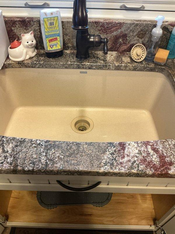 Responded to utility room drain leak in a 32-year-old residential property. Upon inspection, accessed plumbing beneath sink and examined P-trap assembly and drain connections for source of reported leak. Verified proper drainage function, checked for loose fittings, and ensured all connections were secure and watertight.