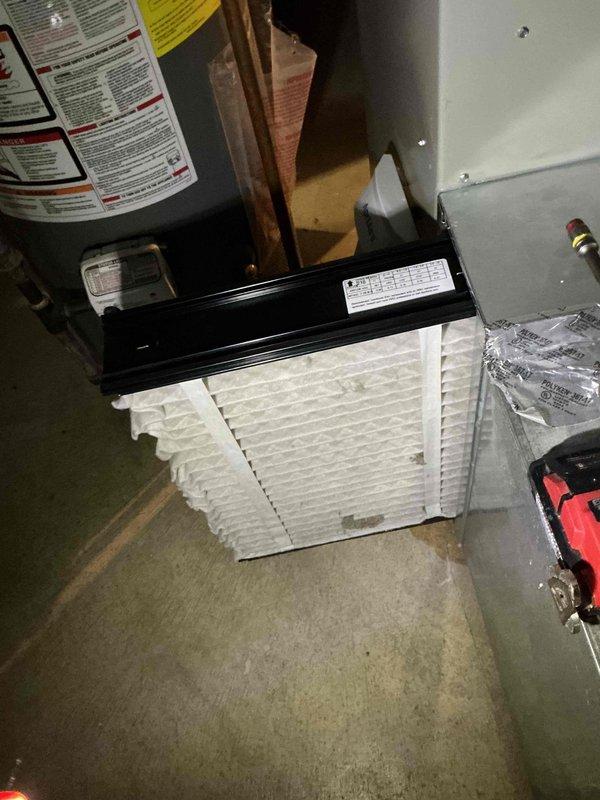 Performed comprehensive cooling system tune-up on 4-year-old residential air conditioning unit. Completed routine maintenance inspection of indoor air handler located in basement utility area, including air filter evaluation showing moderate dust accumulation on pleated media. Inspected outdoor condenser unit with cylindrical housing positioned on concrete pad, verified proper operation of fan assembly, examined refrigerant lines and electrical connections, and confirmed system functionality with no issues or deficiencies noted during service call.