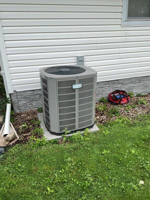 Performed comprehensive cooling system tune-up on 4-year-old residential air conditioning unit. Completed routine maintenance inspection of indoor air handler located in basement utility area, including air filter evaluation showing moderate dust accumulation on pleated media. Inspected outdoor condenser unit with cylindrical housing positioned on concrete pad, verified proper operation of fan assembly, examined refrigerant lines and electrical connections, and confirmed system functionality with no issues or deficiencies noted during service call.