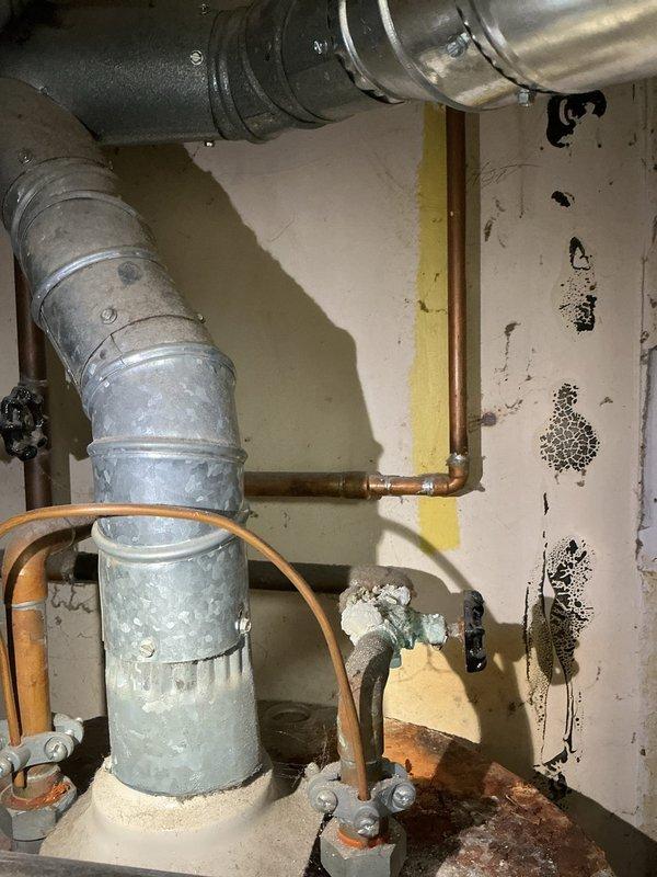 Responded to service call for pilot light failure on tanked water heater in 70-year-old residential property. Upon inspection of utility area, assessed aging copper supply lines, shutoff valves, and gas line connections showing significant oxidation and corrosion consistent with original installation. Diagnosed pilot assembly malfunction, cleaned thermocouple and pilot orifice, verified gas supply pressure, and successfully relit pilot light. Tested burner ignition sequence and confirmed proper operation of temperature/pressure relief valve and all safety controls before returning unit to service.