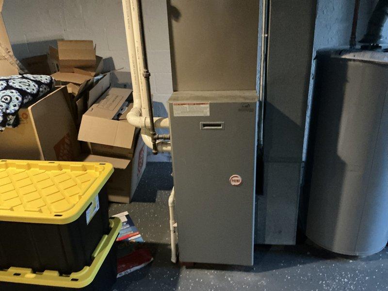 Completed estimate for furnace replacement on 20+ year old unit with failed inducer motor. Assessed existing HVAC system in basement utility area and provided replacement options for aging furnace, with discussion of future air conditioning replacement to be considered in following year. Documented existing equipment configuration and installation requirements.