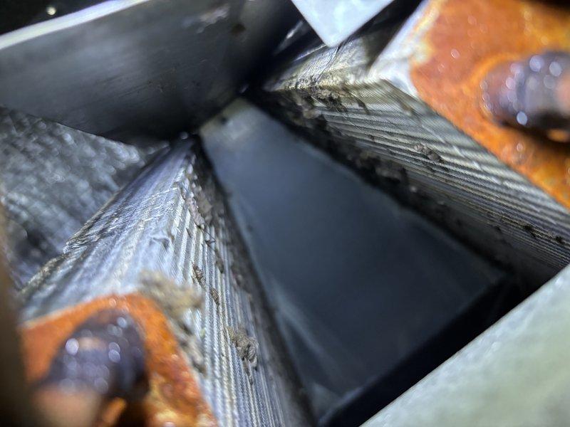 Performed comprehensive AC tune-up on 10-year-old cooling system with no reported issues. Conducted thorough inspection of evaporator coil, noting accumulated dust and debris on fins which was cleaned to restore optimal airflow and heat transfer efficiency. Tested electrical components using clamp meter, recording voltage at 122.6V and amperage at 69A, confirming system operating within normal parameters. Inspected capacitor, wiring connections, and mounting grommets, all showing proper condition with evidence of normal condensation. System tested and verified operational.