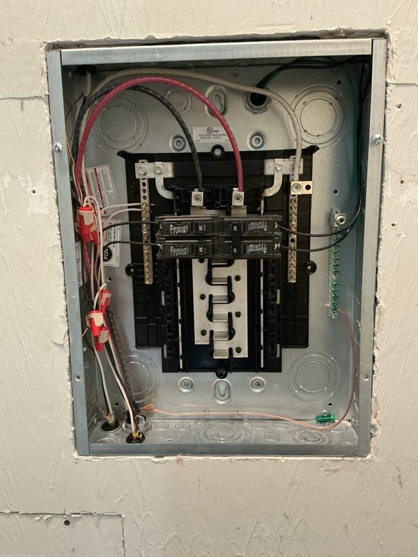 Installed a recessed subpanel in the garage to the right of the existing main electrical panel to increase circuit capacity. Relocated two circuits from the main panel to the new subpanel to accommodate the installation of the subpanel feeder breaker, completing all necessary wiring connections and ensuring proper grounding throughout the installation.