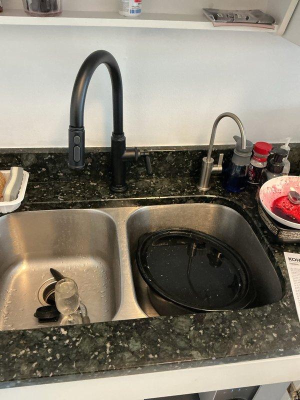 Completed installation of customer-supplied Delta reverse osmosis filtration system under kitchen sink. Connected RO unit to existing cold water supply line and drain assembly, integrated dedicated faucet into countertop alongside main kitchen faucet, and verified proper water flow and filtration operation. System tested successfully with no leaks detected at connections or fittings.