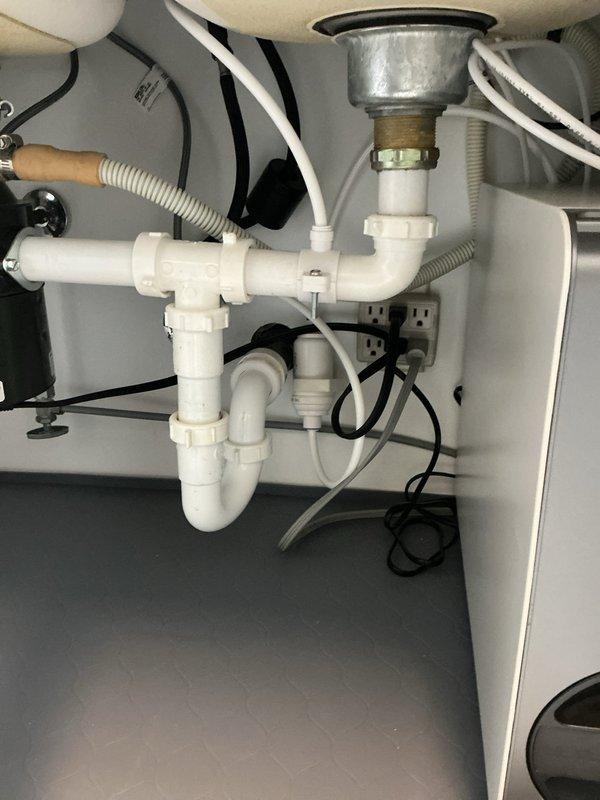 Completed installation of customer-supplied Delta reverse osmosis filtration system under kitchen sink. Connected RO unit to existing cold water supply line and drain assembly, integrated dedicated faucet into countertop alongside main kitchen faucet, and verified proper water flow and filtration operation. System tested successfully with no leaks detected at connections or fittings.