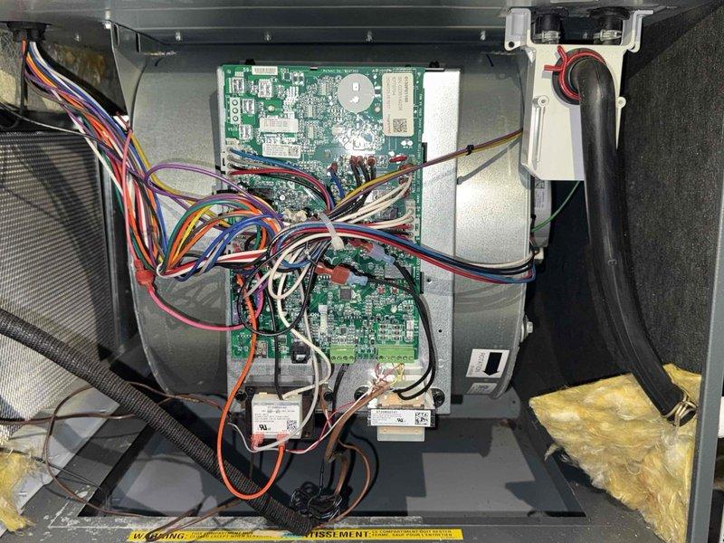 Completed preventive maintenance service on a two-year-old Lennox air conditioning system with no reported operational issues. Performed comprehensive AC tune-up including inspection of outdoor condensing unit, verified proper electrical connections at disconnect box, examined control boards and wiring harnesses inside unit compartment, checked condensate drainage system components, and confirmed all safety labels were intact. Unit operating within normal parameters with all systems functioning properly at time of service completion.