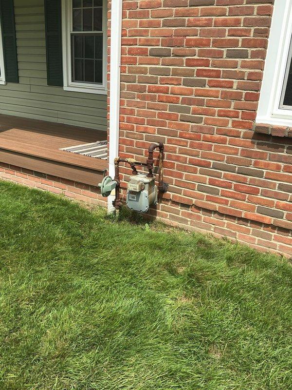 Conducted site assessment for natural gas line installation to accommodate upcoming pool installation. Evaluated existing gas meter location on exterior brick wall and assessed routing path through basement ceiling joists to proposed pool equipment area. Documented current infrastructure and measured run distance to provide accurate estimate for gas line extension project.