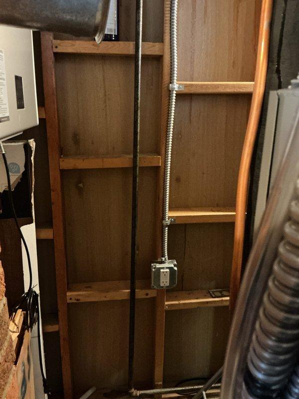Installed dedicated electrical circuit for tankless water heater system. Ran new flexible metal conduit from main electrical panel through wall framing to equipment location, mounted junction box, and connected appropriate circuit breaker in panel to support tankless unit power requirements.