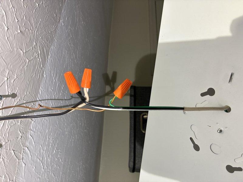 Installed customer-supplied lighting fixtures in residential bathroom and laundry room, including a three-light vanity fixture with cylindrical glass shades mounted above mirror and vanity area. Completed electrical connections using appropriate wire nuts and junction boxes, ensuring all wiring met code requirements and fixtures were properly secured to mounting surfaces.