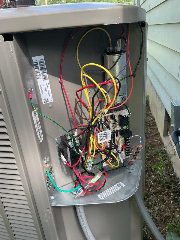 Responded to service call for thermostat not maintaining set temperature following PCB replacement from previous week. Inspected outdoor unit electrical components and control board connections, verified proper wiring configuration and capacitor function. System evaluated and found operating within normal parameters with all electrical connections secure.