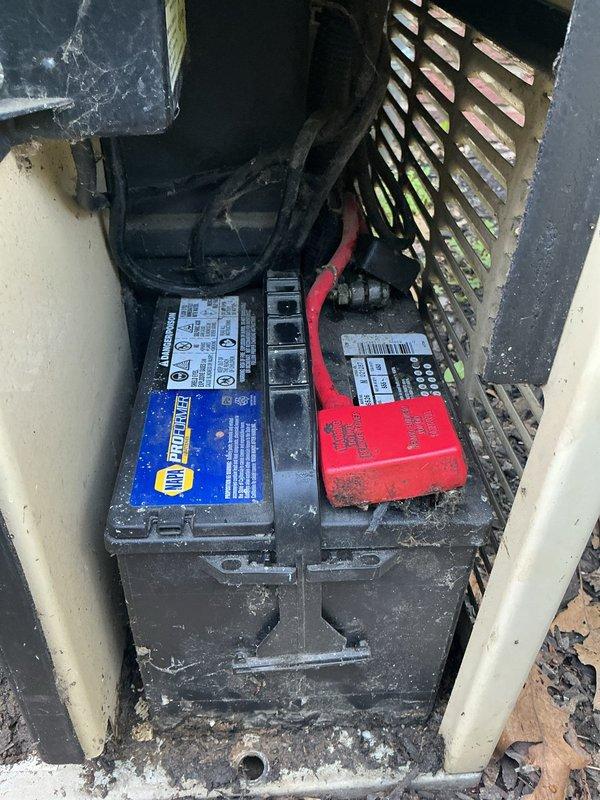 Responded to diagnostic call for 15-year-old Kohler generator experiencing abbreviated weekly exercise cycles, running only 30 seconds to 1 minute instead of the programmed 15-minute duration. Upon arrival, opened generator enclosure and performed visual inspection of internal components, engine assembly, and control panel. Inspected battery compartment revealing two batteries with visible corrosion, debris accumulation, and potential connection issues. Documented equipment condition through photographic evidence showing overall system layout, control interfaces, and battery configuration. Generator housing showed normal weathering for age with adequate ventilation maintained. Identified potential causes for shortened run cycle including battery voltage irregularities, control board programming drift, or exercise timer malfunction requiring further diagnostic testing or component replacement to restore proper weekly exercise function.