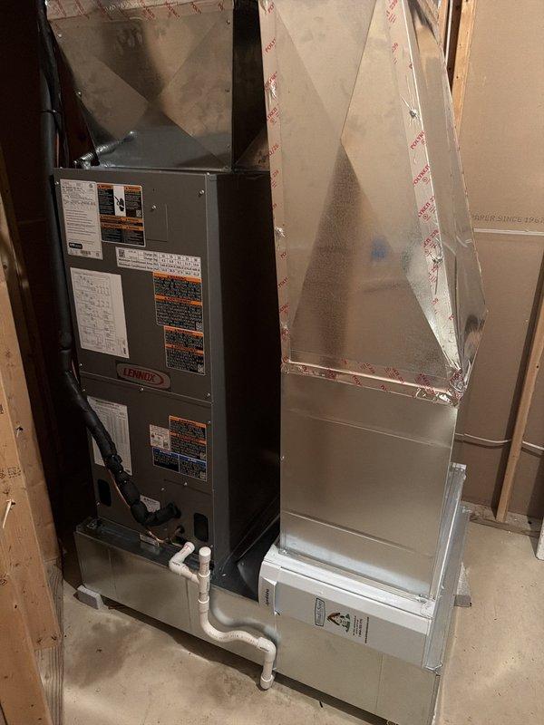 Completed full HVAC system installation consisting of a Lennox air handler and matching air conditioning unit in residential basement utility area. Installed both units on concrete pad with proper clearances, established electrical connections with appropriate fusing (JLNR 204 time-delay fuses), and ran PVC condensate drain lines from air handler. System commissioned and verified operational per manufacturer specifications.