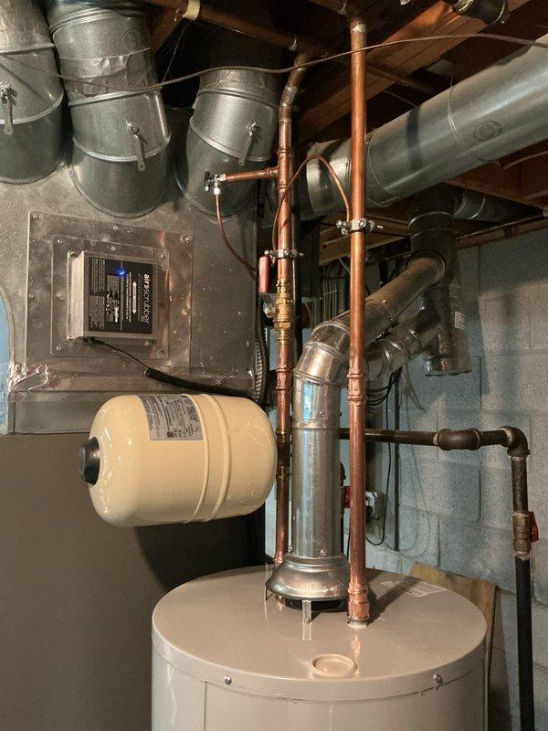 Replaced leaking 2019 40-gallon tall water heater with new Bradford White 40-gallon unit featuring 6-year manufacturer warranty. Installed new thermal expansion tank to protect system from pressure fluctuations. Replaced corroded ball valve and removed existing saddle valve, installing new tee fitting with proper shut-off valve for improved water supply control and code compliance. All components connected with copper piping, system tested and operational upon completion.