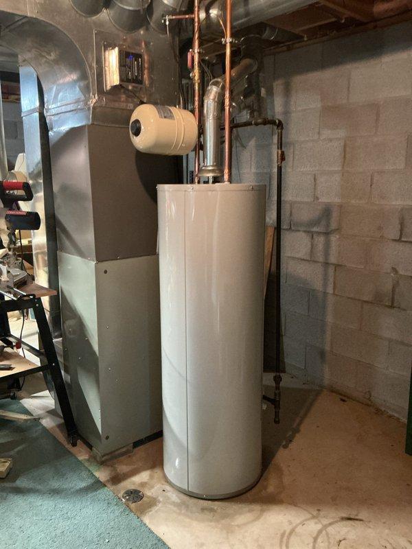Replaced leaking 2019 40-gallon tall water heater with new Bradford White 40-gallon unit featuring 6-year manufacturer warranty. Installed new thermal expansion tank to protect system from pressure fluctuations. Replaced corroded ball valve and removed existing saddle valve, installing new tee fitting with proper shut-off valve for improved water supply control and code compliance. All components connected with copper piping, system tested and operational upon completion.