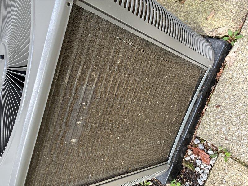 Completed comprehensive air conditioning tune-up on outdoor condensing unit. Inspected blower motor assembly and squirrel cage fan, confirming proper operation and structural integrity. Noted significant debris accumulation and soiling on condenser coil mesh requiring cleaning to restore optimal heat transfer efficiency and system performance.