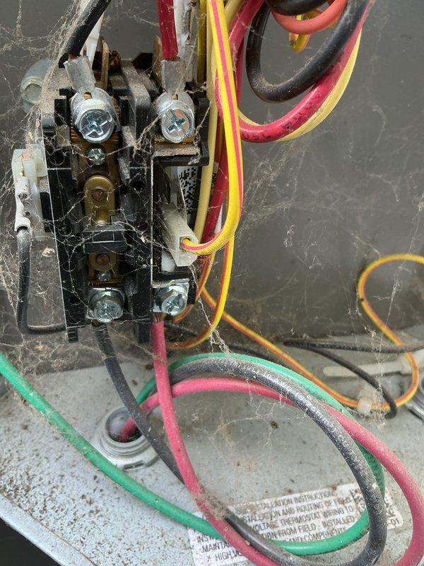 Completed comprehensive tune-up on 6-year-old air conditioning system, including inspection of exterior disconnect box and contactor assembly. Observed accumulated debris and cobwebs around electrical connections indicating need for routine maintenance; cleaned terminals and verified proper electrical connections on contactor with multiple wire terminations. Installed complimentary carbon monoxide detector as part of seasonal safety promotion.